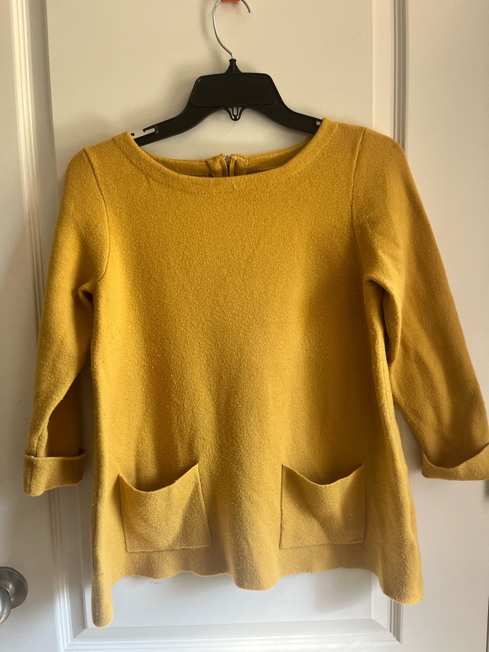 Yellow knit top with pockets and cuffed sleeves